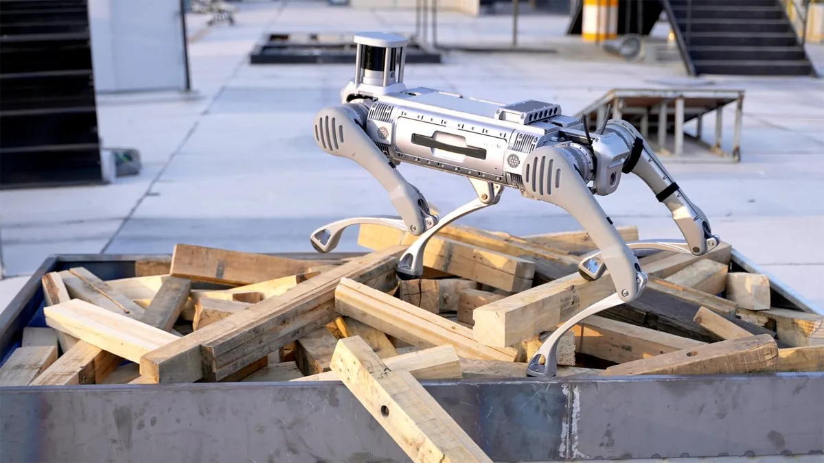Four-legged robot walks across wooden beams on a construction site